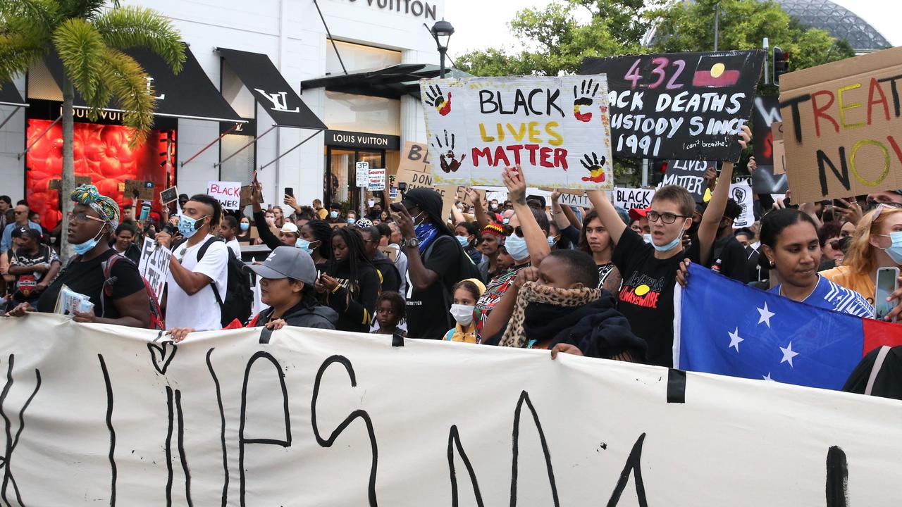 Thousands march through the Cairns CBD chanting and waving placards to protest black deaths in custody and support the Black Lives Matter movement. Picture: PETER CARRUTHERS