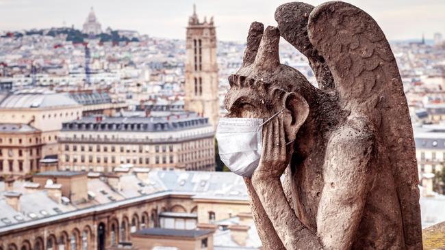 A mask on a gargoyle on Notre Dame in Paris. Picture: iStock