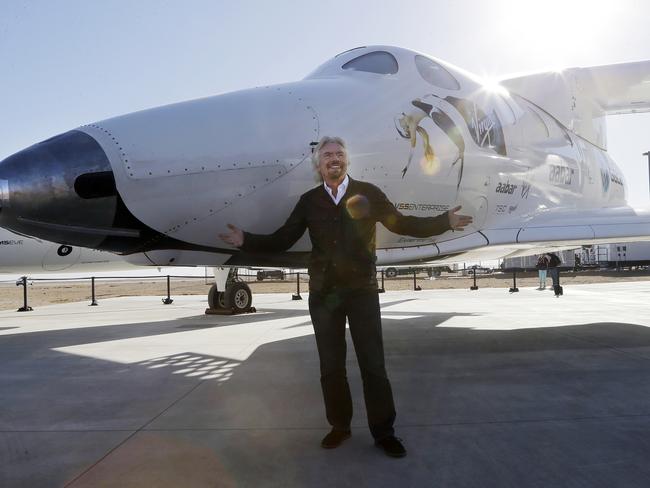 Proud moment ... Richard Branson poses with SpaceShipTwo on September 25, 2013 at a Virgin Galactic hangar at Mojave Air and Space Port in Mojave, California. Picture: AP / Reed Saxon