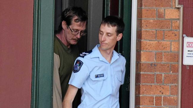Ross William Thompson of Calico Creek is lead from the Gympie Magistrates court by Senior Constable Daniel Poole on Wednesday October 9, 2019. Picture: Donna Jones