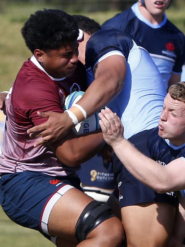 Qld Reds' Lehopo Leota cops a big hit from Waratahs' Edwin Langi and Nick Ashdown in an under 18s battle last year. Langi scored in the weekend’s battle.