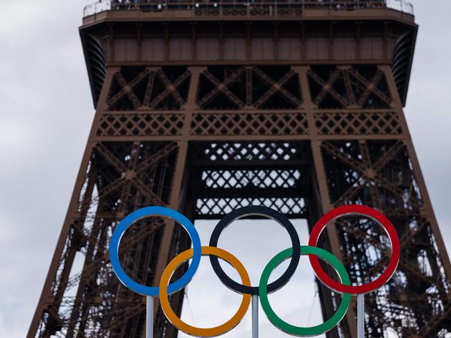 This photograph shows the Olympic Rings displayed at the construction site of the Eiffel Tower Stadium for the upcoming Paris 2024 Olympics and Paralympic Games which will host the Beach Volleyball and men's Blind Football competitions, at the Champ-De-Mars in Paris on July 10, 2024. The Champ de Mars and the Trocadero, located on either side of the Eiffel Tower, will host several events of the Paris Olympic and Paralympic Games, on July 10, 2024. (Photo by Dimitar DILKOFF / AFP)