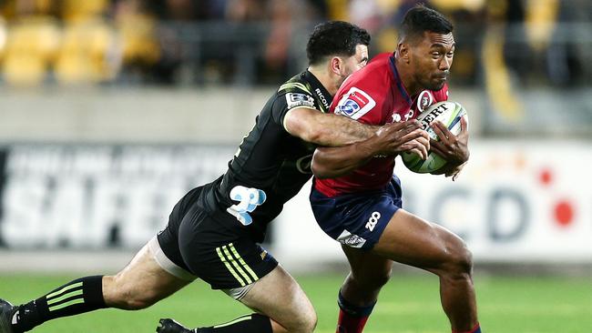 Queensland’s Aidan Toua of the Reds is tackled by Nehe Milner-Skudder of the Hurricanes.