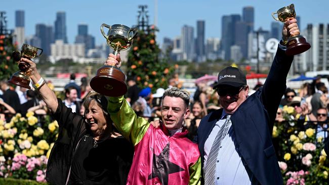 Irish jockey Robbie Dolan celebrates with trainers Sheila Laxon and John Symonds after riding Knight's Choice to victory in the 2024 Melbourne Cup. Picture: William West