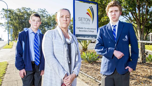 Parent Nicky Reed with 14-year-old Kyal and 16-year-old Tyler outside Seton College. Picture: Richard Walker