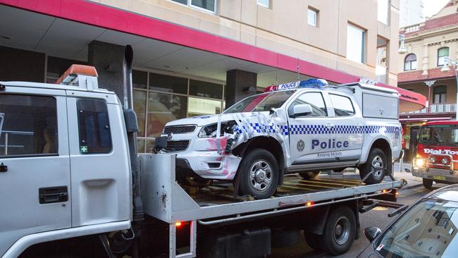 A damaged police van is taken away. Picture: Scott Oates