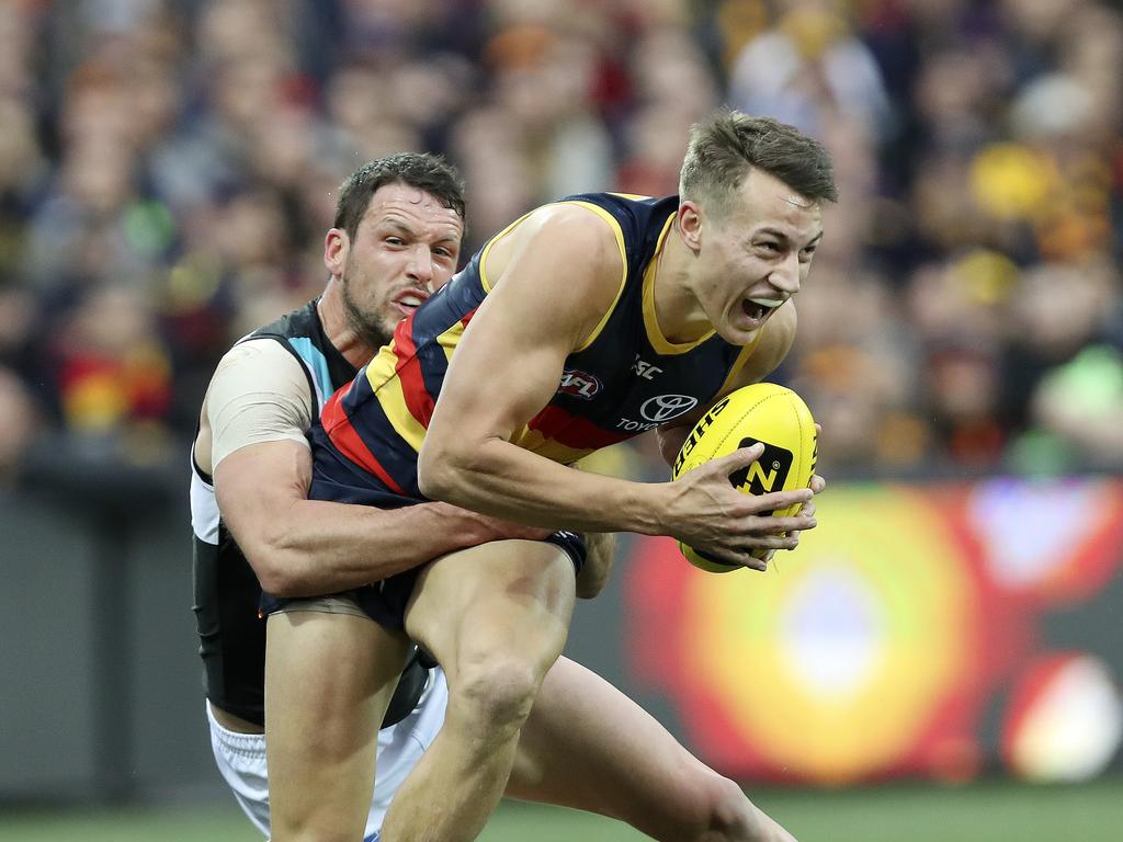 Port’s Travis Boak tackles Crows’ Tom Doedee. Picture SARAH REED