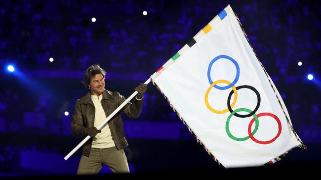 PARIS, FRANCE - AUGUST 11: Actor Tom Cruise holds the Olympic flag during the Closing Ceremony of the Olympic Games Paris 2024  at Stade de France on August 11, 2024 in Paris, France. (Photo by Fabrizio Bensch- Pool/Getty Images)