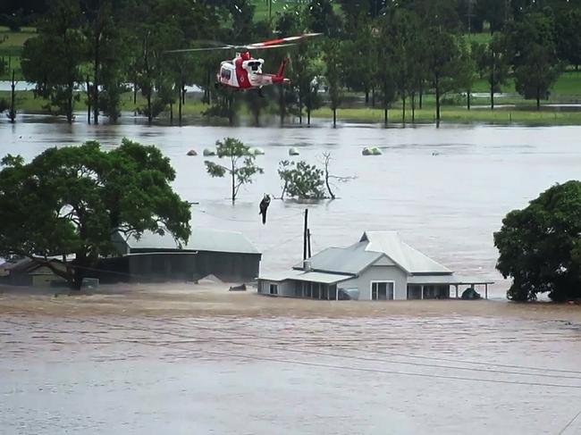 A screenshot taken from video posted by NSW RFS showing a helicopter evacuation in the Taree area.Picture: Twitter / @NSWRFS