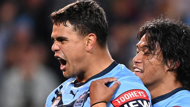 GOLD COAST, AUSTRALIA - JULY 14: Latrell Mitchell of the Blues celebrates with Brian To'o of the Blues after scoring a try during game three of the 2021 State of Origin Series between the New South Wales Blues and the Queensland Maroons at Cbus Super Stadium on July 14, 2021 in Gold Coast, Australia. (Photo by Bradley Kanaris/Getty Images)