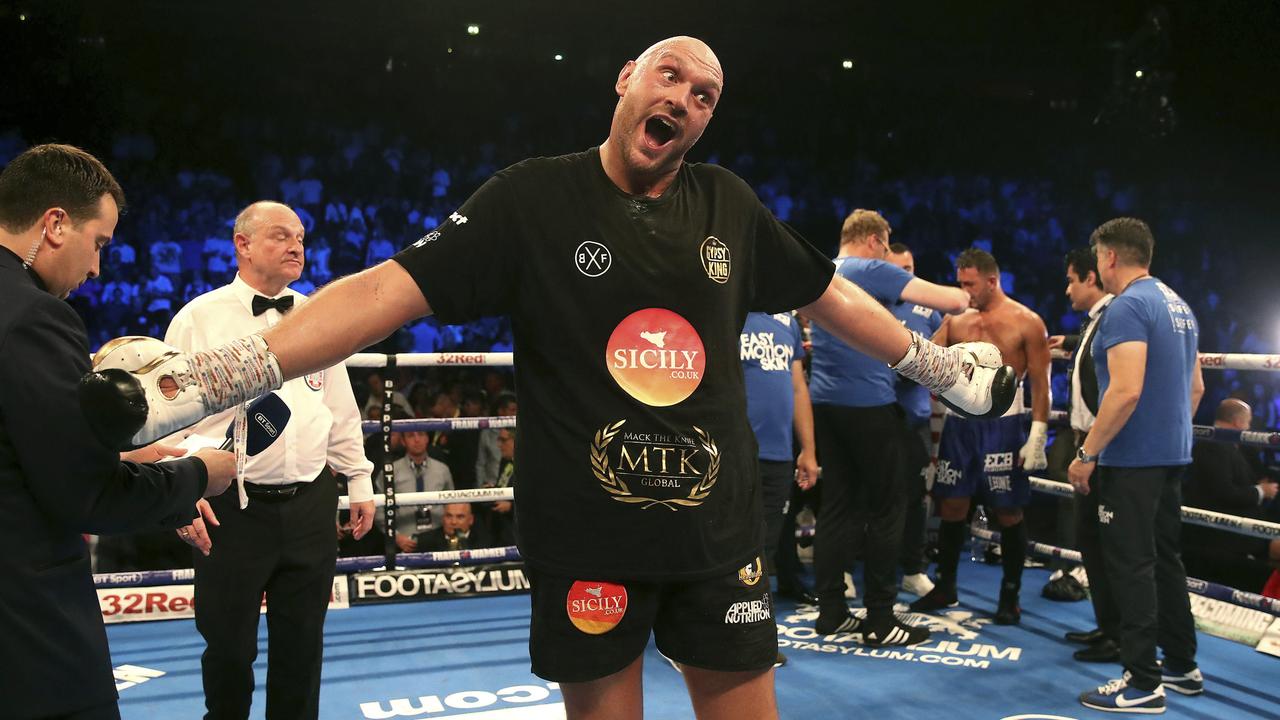 Britain's Tyson Fury, centre, celebrates beating Sefer Seferi in their heavyweight bout at the Manchester Arena, in Manchester, England, Saturday June 9, 2018. (Nick Potts/ PA via AP)