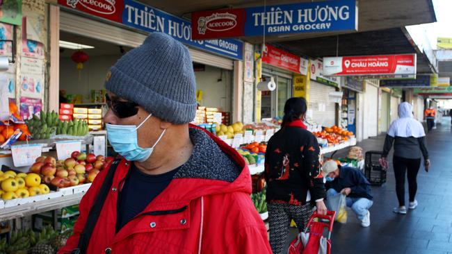 Shoppers wearing face masks and buying food items along Chapel Road in Bankstown. Photo: Lisa Maree Williams/Getty Images