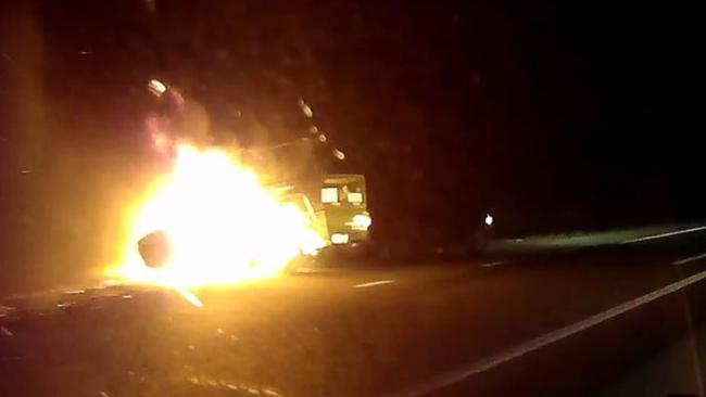 A man finally pulls over for police after towing his fully ablaze trailer down the Bruce Highway. Picture: Queensland Police Service