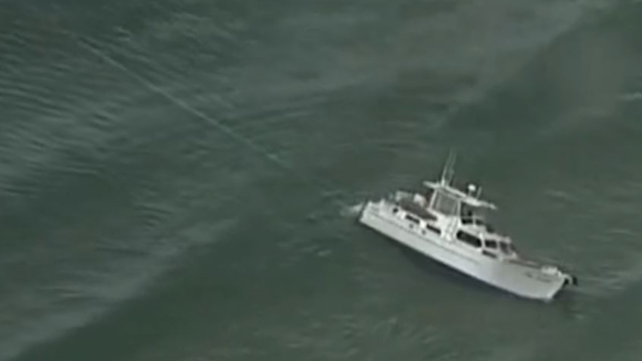 Crews attempt to pull the M.V. Focus off the beach. Picture: 7 News