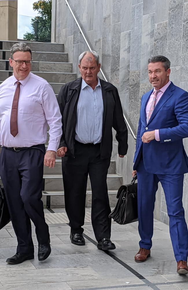 Oil Tech International Pty Ltd director Michael Joseph Reid (centre) leaving Beenleigh District Court flanked by his legal representatives. The charge against Mr Reid was dropped. Picture: Alex Treacy