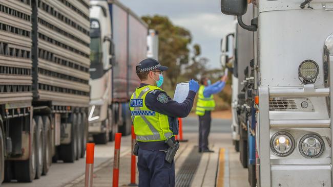 SA Police check truck drivers at the Yamba checkpoint on the SA-Victoria border. Picture: Darren Seiler.