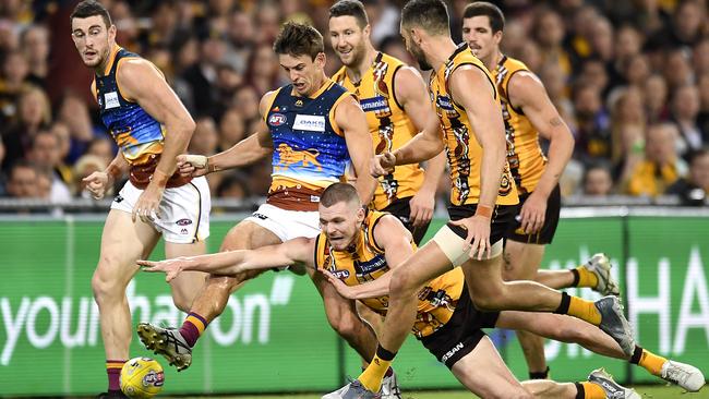 Jarryd Lyons gets a kick away against the Hawks. Picture: Getty Images