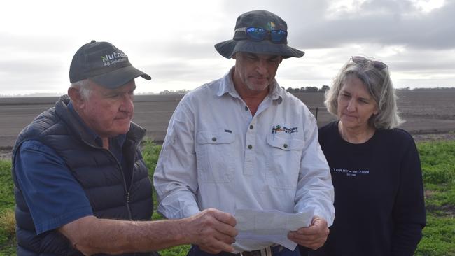 Kupunn landholders Wayne Newton, Mark Schuurs, and Zena Ronnfeldt looking at the maps of wells underneath their properties. Picture: Sam Turner