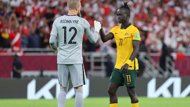 Mabil is encouraged by goalkeeper Andrew Redmayne before his shot in the penalty shootout. Picture: Karim Jaafar/AFP