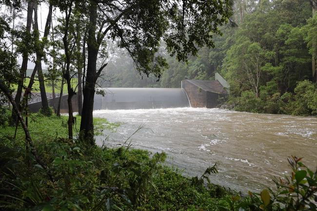 Water pours over Tallebudgera Dam weir after the heavy rains. Picture: Glenn Hampson.