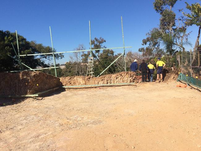 Riverbank House, after the initial excavation with client and builders looking over the edge toward river. Photo: Supplied