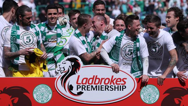 Celtic players celebrate their fifth straight Scottish Premiership title.