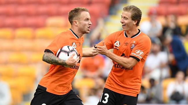 Brisbane Roar’s Adam Taggart, left, after scoring against the Mariners on Sunday