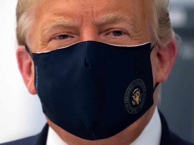 US President Donald Trump wears a mask with the official seal on it. Picture: AFP