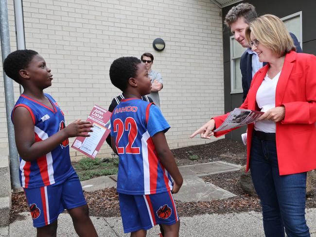 Young kids talk to Premier Jacinta Allan and Labor candidate John Lister at a polling booth on Saturday. Picture: David Crosling