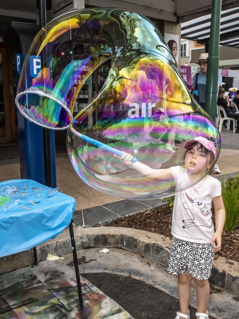 5 year old Amelia Cash makes the best bubbles at the Russell Street Refresh block party. Saturday, November 20, 2021. Picture: Nev Madsen.