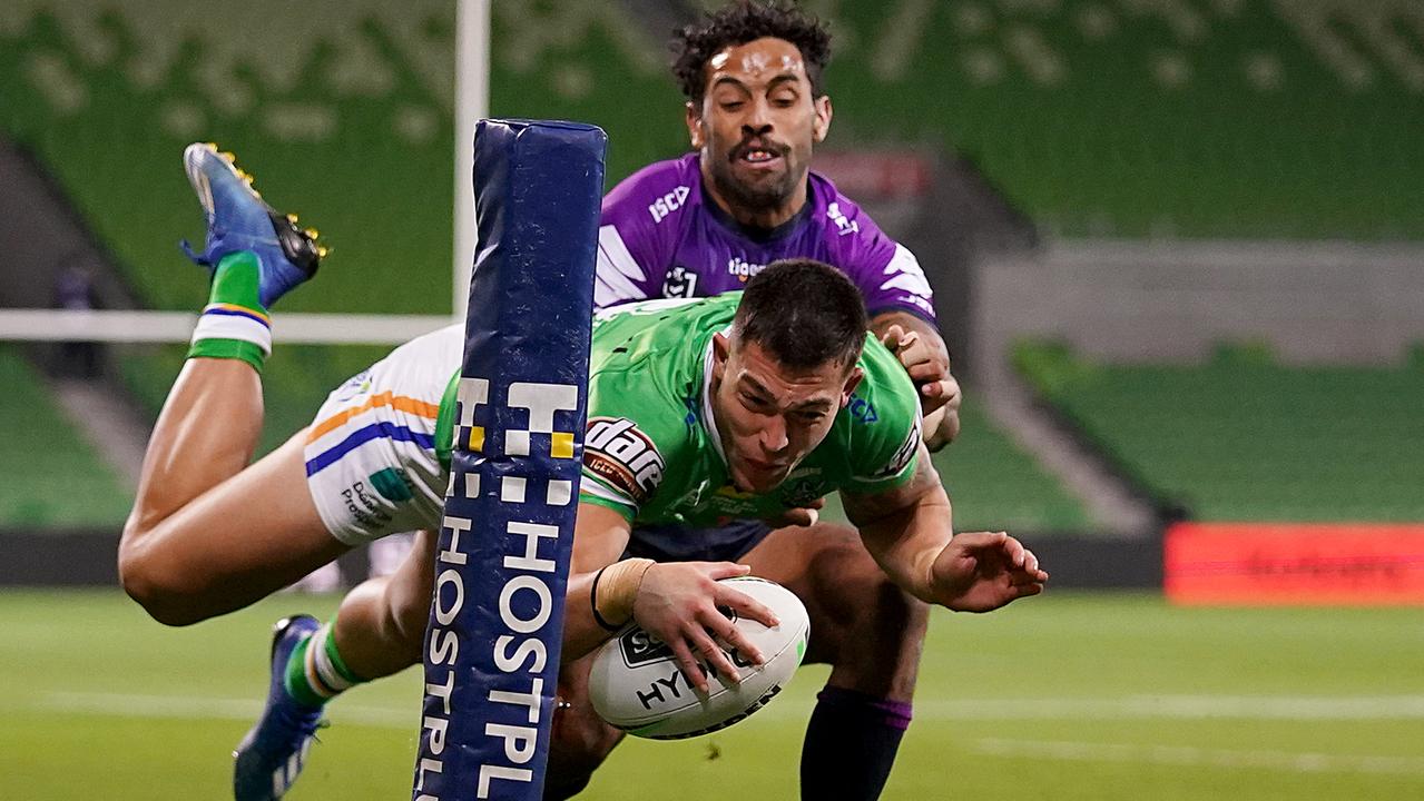 Nick Cotric of the Raiders scores a try ahead of Melbourne’s Josh Addo-Carr.