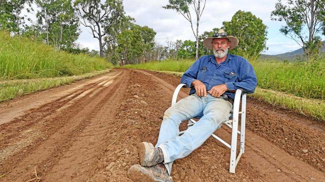 YOU SHALL NOT PASS: Armed with a chair, an esky, and anger at council's road maintenance, David Golding blocked a grader from doing its work on Sexton Rd yesterday in a solo protest. Picture: Troy Jegers