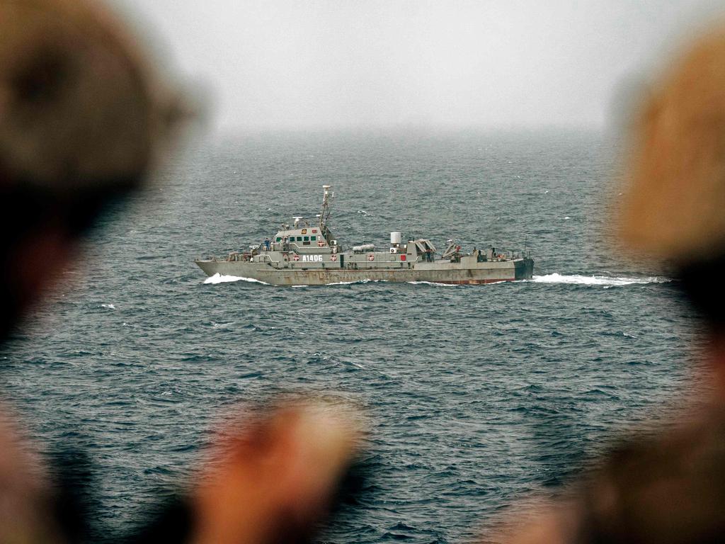 US sailors keep watch on Iranian fast attack craft in the Strait of Hormuz. Picture: Navy Office of Information / AFP