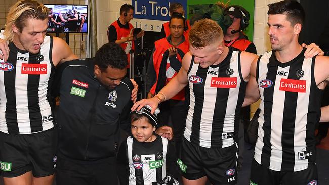 Brain cancer sufferer Kyron McGuire sings the club song with his Collingwood heroes. Picture: Getty Images