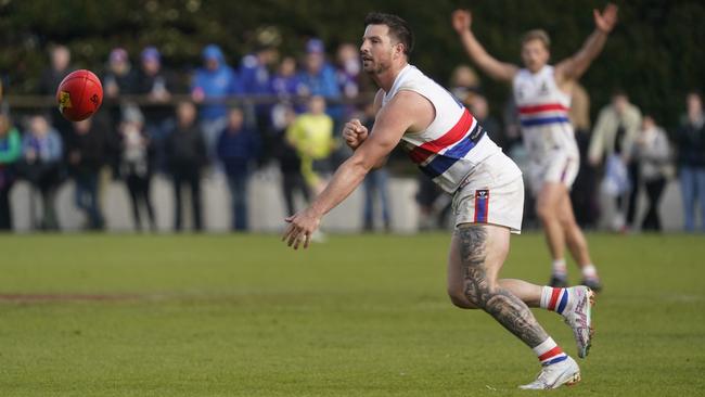 Adrian Speedy fires off a handball in last season’s Division 2 grand final. Picture: Valeriu Campan