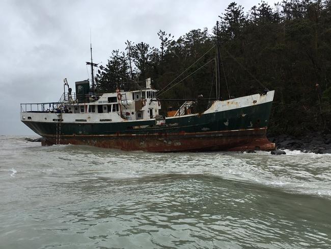 A police rigid-hulled inflatable boat was deployed to the stranded boat, and the men aboard were able to lower themselves down into the RHIB. They have now been taken to Shute Harbour by police. Picture: Queensland Police