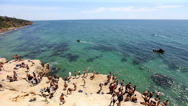 People jumping off the Pillars cliff at Mount Martha. Picture Yuri Kouzmin