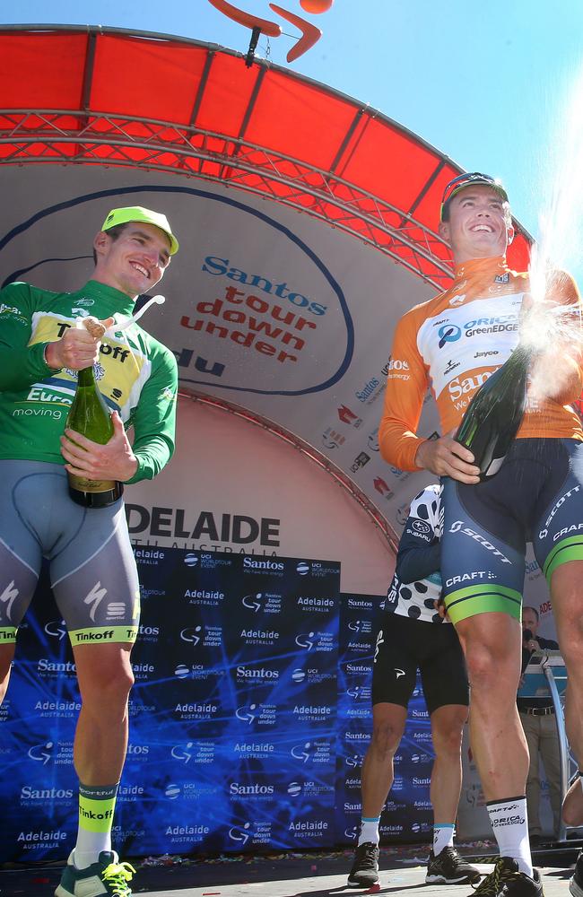 Simon Gerrans stands on the podium spraying champagne with Jay McCarthy. Photo: Sarah Reed.