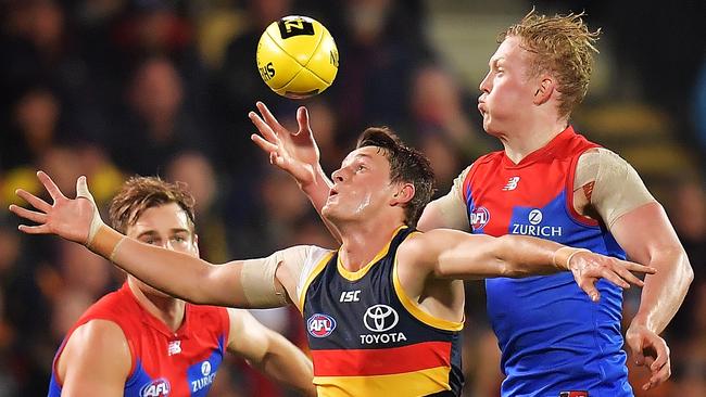 Matt Crouch of the Crows battles Clayton Oliver of the Demons last season. Picture: Daniel Kalisz/Getty Images