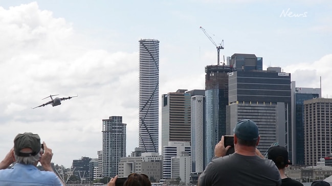 Watch: Huge cargo plane flies insanely close to Brisbane skyscrapers