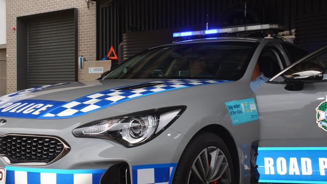 NEW WHEELS: Police minister Mark Ryan and Dalby-Burnett road policing unit officer in charge Mark Worowitz check out Kingaroy Police's new marked Kia 'Stinger.'