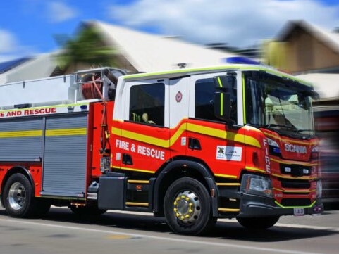 AIRLIE BEAH, QLD - OCT 02 2022:Australian firetruck rushing to scene.The global fire trucks market size was estimated at USD 4.30 billion in 2015.