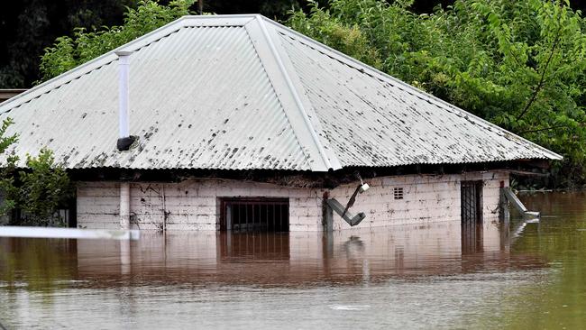 A house is seen inundated by the floodwater in southwestern suburb of Camden on March 8. Picture: Muhammad Farooq/AFP