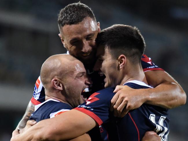 Rebels Billy Meakes  and Quade Cooper congratulate Jack Maddocks after he scores a try during the Round 1 Super Rugby match between the Brumbies and the Melbourne Rebels at GIO Stadium in Canberra, Friday, February 15, 2019. (AAP Image/Mick Tsikas) NO ARCHIVING, EDITORIAL USE ONLY