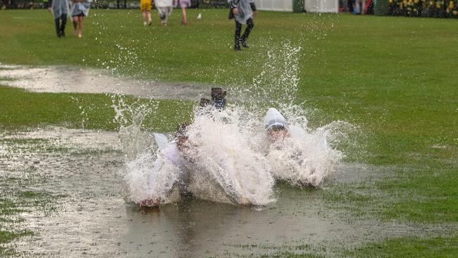 Not even a downpour can stop the fun at Flemington. Picture: Jason Edwards