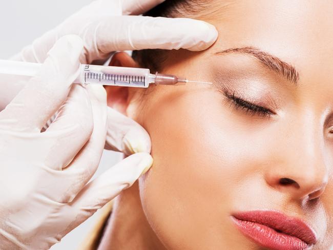 A woman undergoes a beauty treatment with Botox