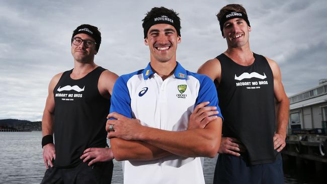 Members of the Mobart Mo Bros running in the Point to Pinnacle, Stuart Cooper, left, and Callan Dell, right, with Australian cricketer Mitchell Starc. Picture: NIKKI DAVIS-JONES