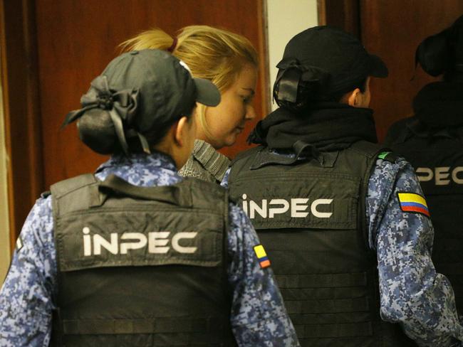 In handcuffs and being dragged away by four female prison guards accused Australian drug mule Cassie Sainsbury exits the Bogota court under tight security. Picture: Gary Ramage