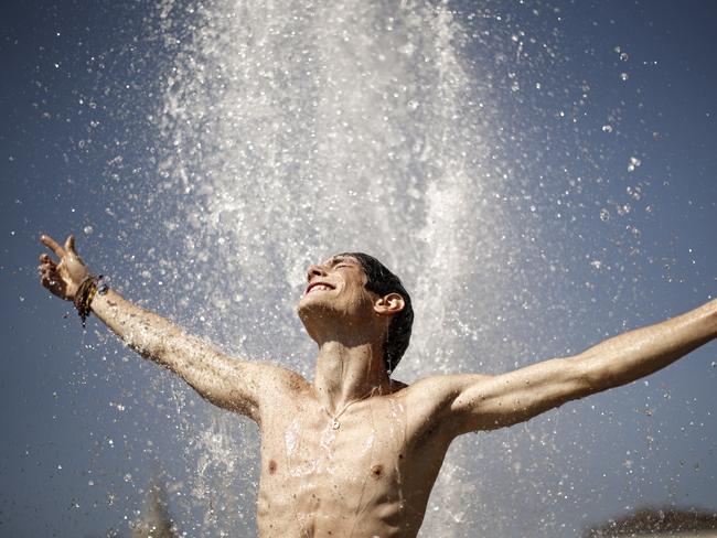 A man refreshes himself as he plays in a fountain in Piazza Castello, in Turin. Picture: AFP