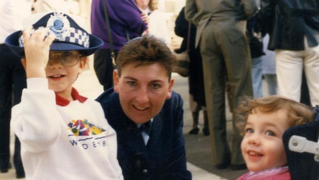 Leading Senior Constable Taylor at her police graduation with her nephew and niece.